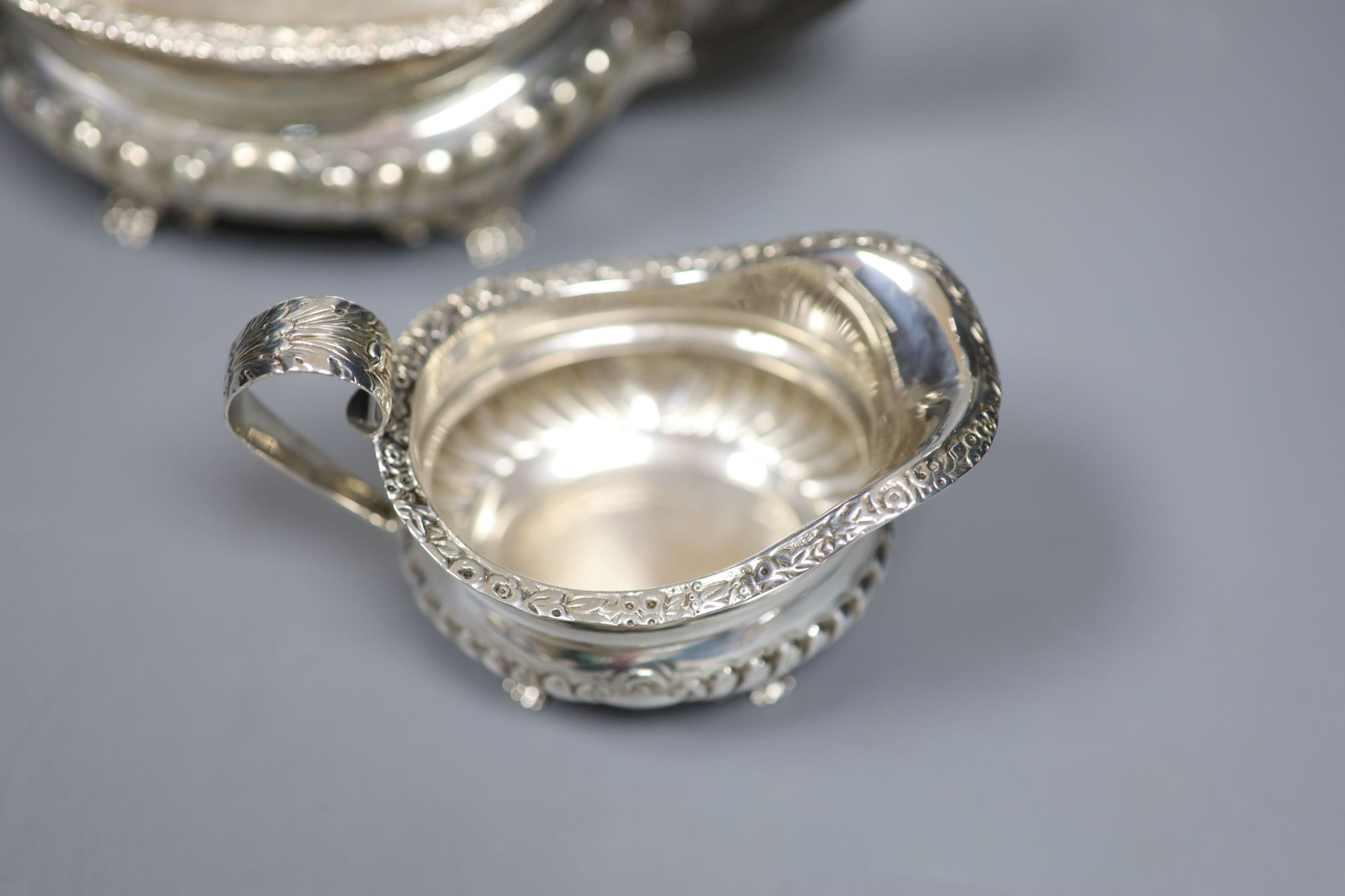 A late Victorian demi fluted silver three piece tea set, Charles Stuart Harris, London, 1899, gross 25.5oz (a.f.).